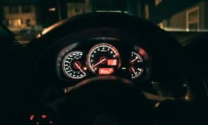 a car dashboard with a speedometer