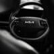 a black and white photo of a car steering wheel