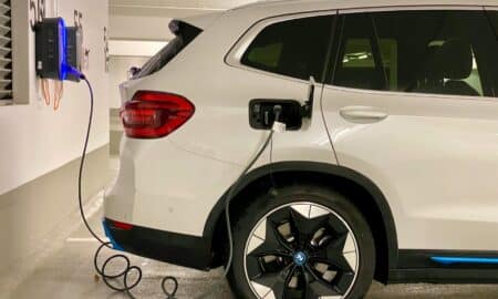 an electric car plugged in to a charging station