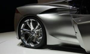a silver sports car on display at a show