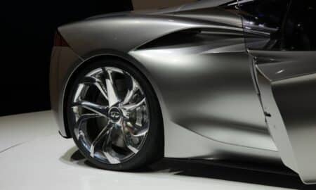 a silver sports car on display at a show