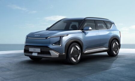 a blue suv parked in front of a building