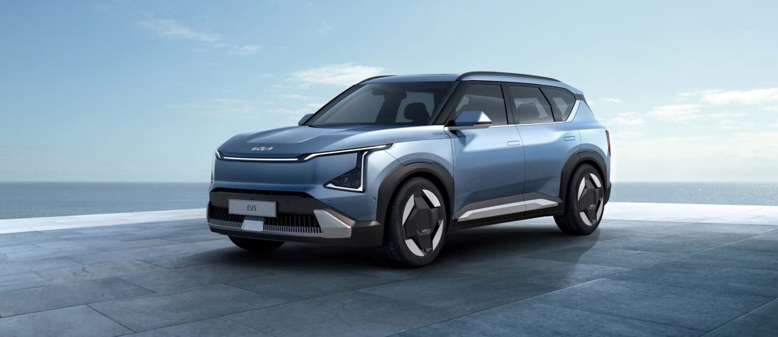 a blue suv parked in front of a building