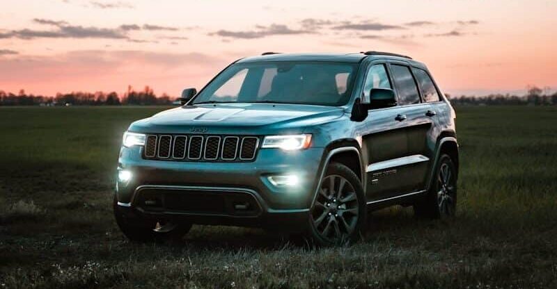 gray bmw x 6 on green grass field during sunset