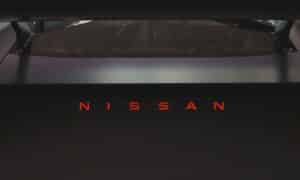 Nissan logo illuminated in red on a dark car