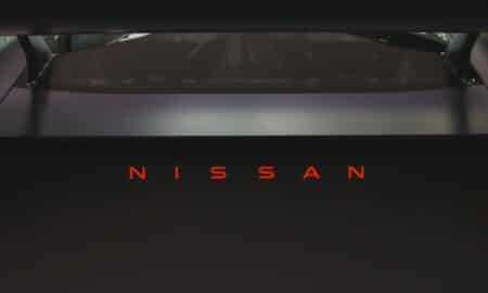 Nissan logo illuminated in red on a dark car
