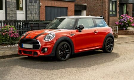 A red mini cooper parked on the side of the road