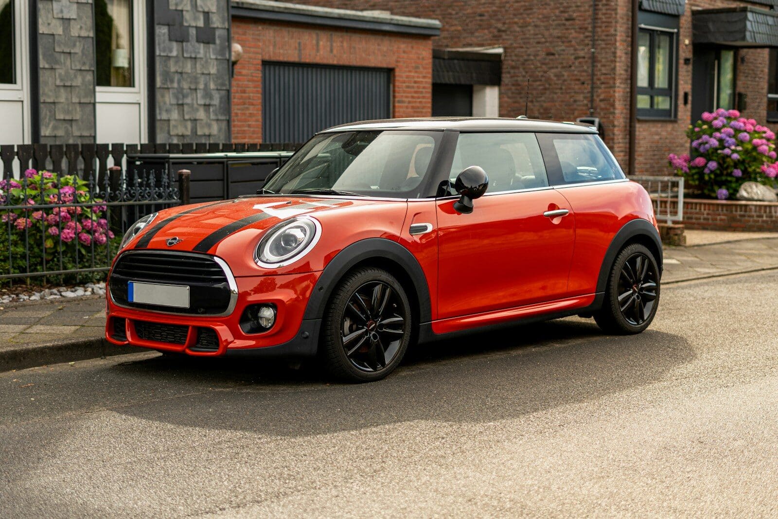A red mini cooper parked on the side of the road