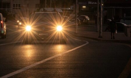 people walking on sidewalk during night time