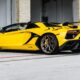 yellow lamborghini aventador parked in front of white building