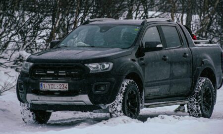 a black truck is parked in the snow