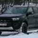 a black truck is parked in the snow