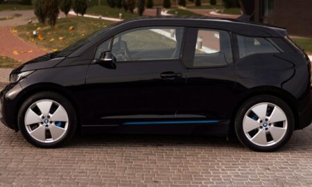 a black car parked on a brick road