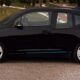 a black car parked on a brick road