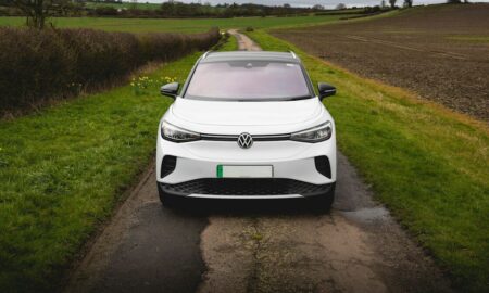 White electric car parked on a rural road