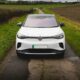 White electric car parked on a rural road