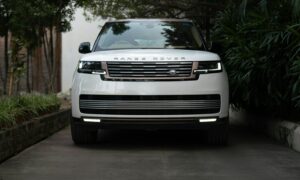 White range rover parked on a paved driveway.
