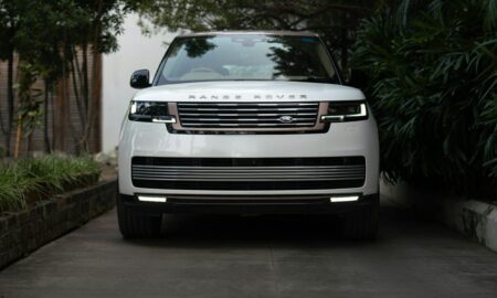 White range rover parked on a paved driveway.