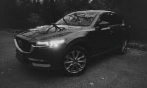 A dark suv parked on a paved road
