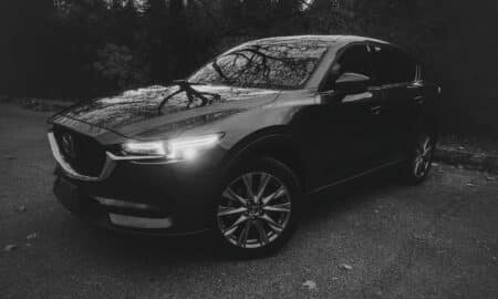 A dark suv parked on a paved road