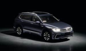 Dark blue suv parked in a studio with spotlights.