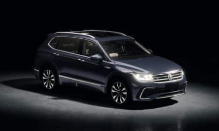 Dark blue suv parked in a studio with spotlights.