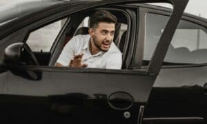 a person sitting on the seat of a car