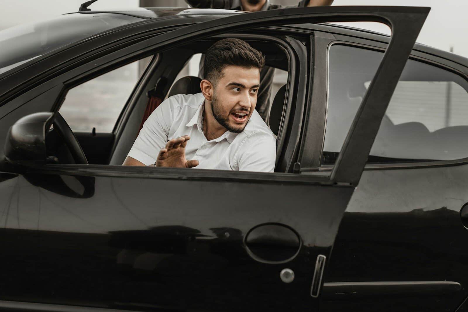 a person sitting on the seat of a car