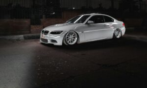 a white car parked in a parking lot at night