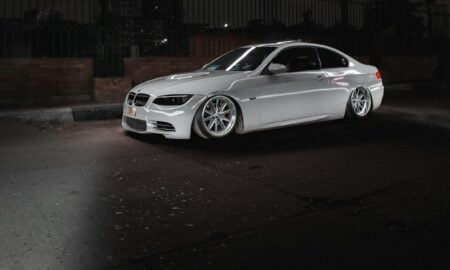 a white car parked in a parking lot at night