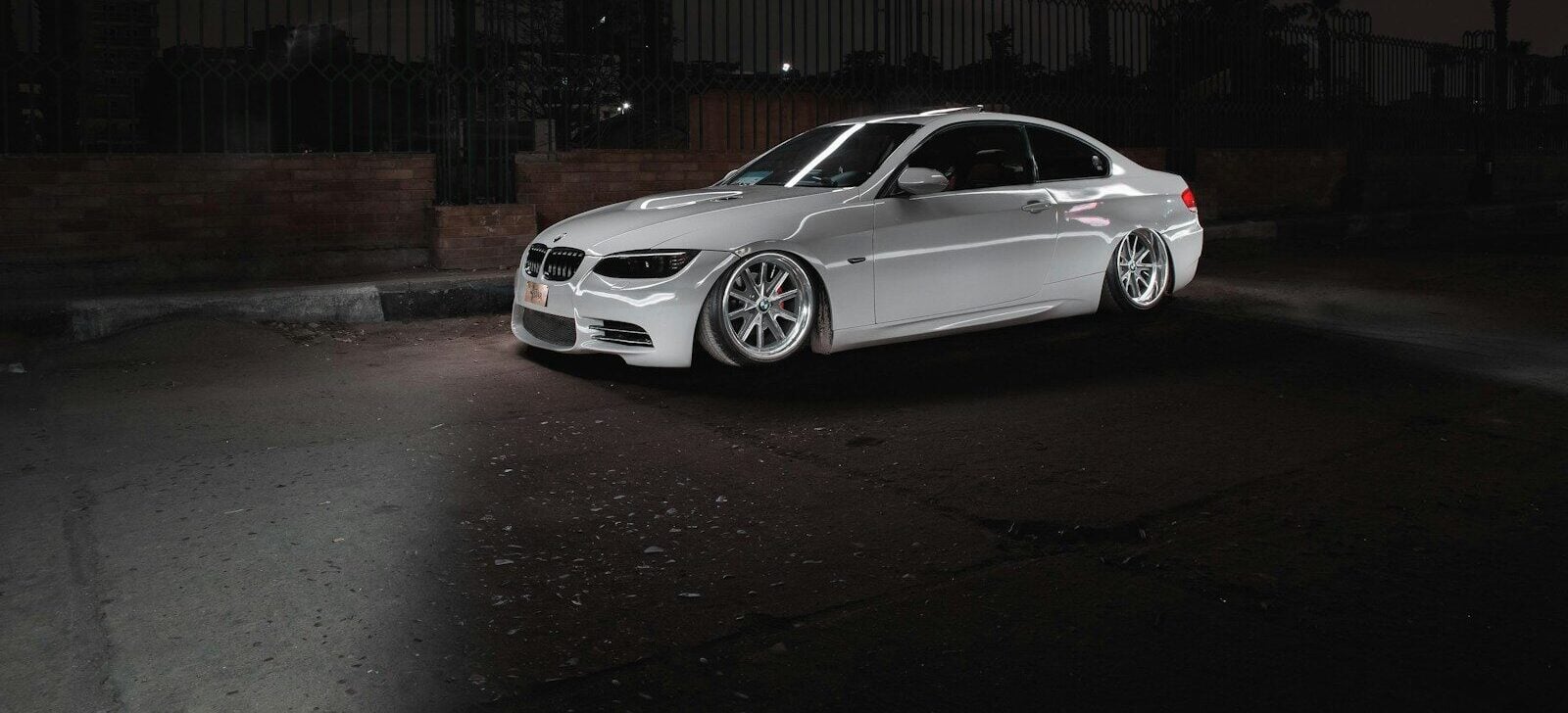 a white car parked in a parking lot at night