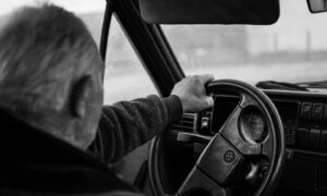 Man driving a car on a blurry day