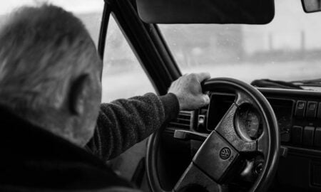 Man driving a car on a blurry day
