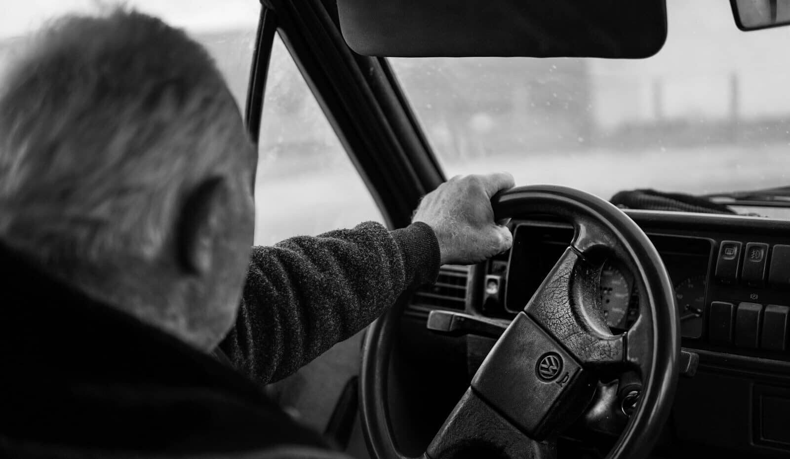 Man driving a car on a blurry day