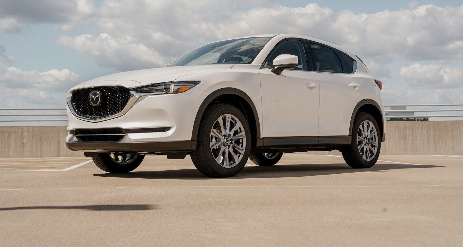 a white mazda cx - 5 parked in a parking lot