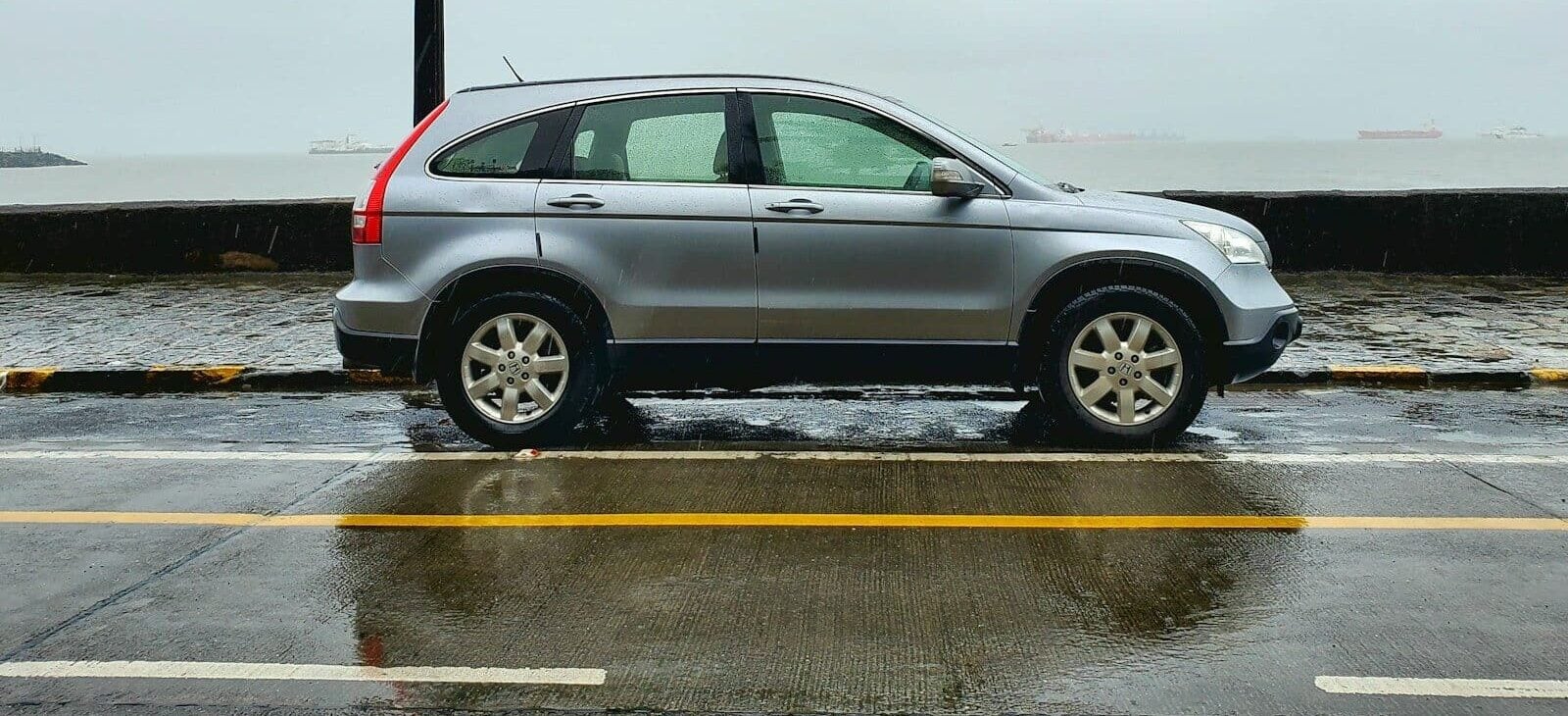 gray suv on gray asphalt road during daytime