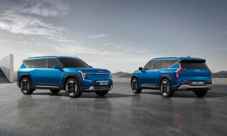 two blue suvs side by side in a parking lot