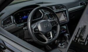 Modern car interior with digital dashboard and steering wheel.