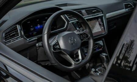 Modern car interior with digital dashboard and steering wheel.