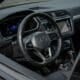 Modern car interior with digital dashboard and steering wheel.