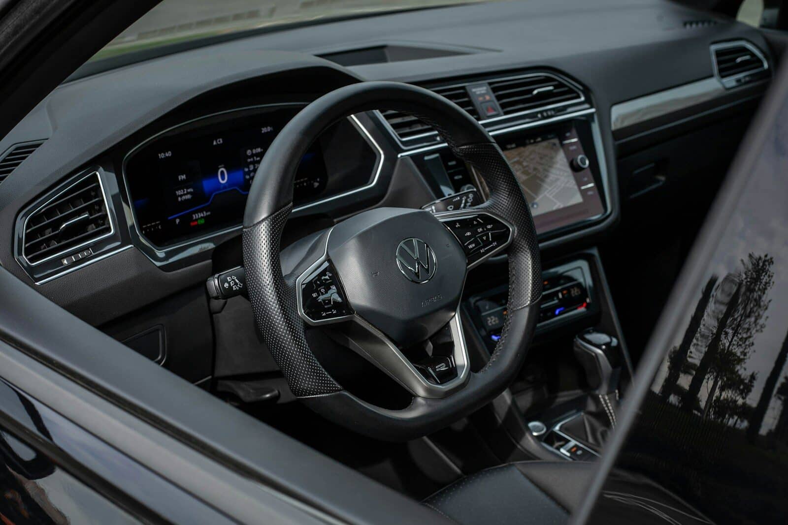 Modern car interior with digital dashboard and steering wheel.