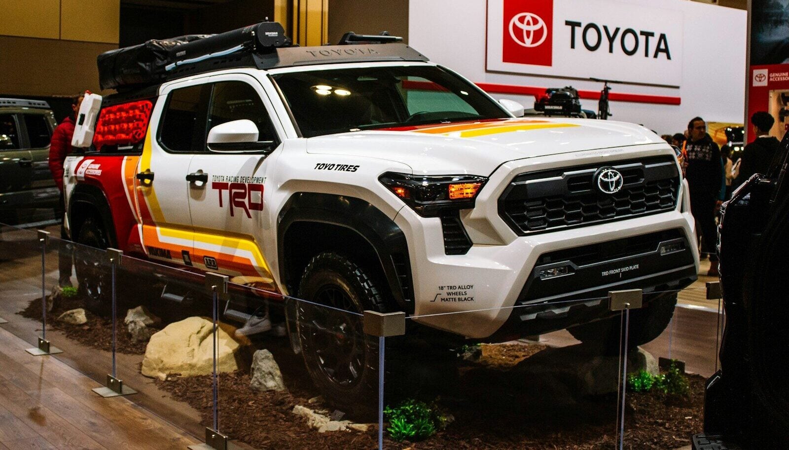 White toyota trd truck with colorful graphics on display