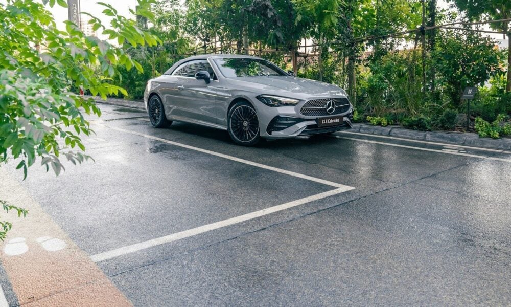 A silver car parked on a wet road