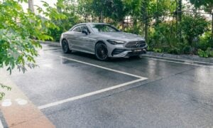 A silver car parked on a wet road