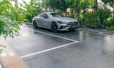 A silver car parked on a wet road