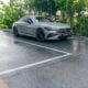 A silver car parked on a wet road