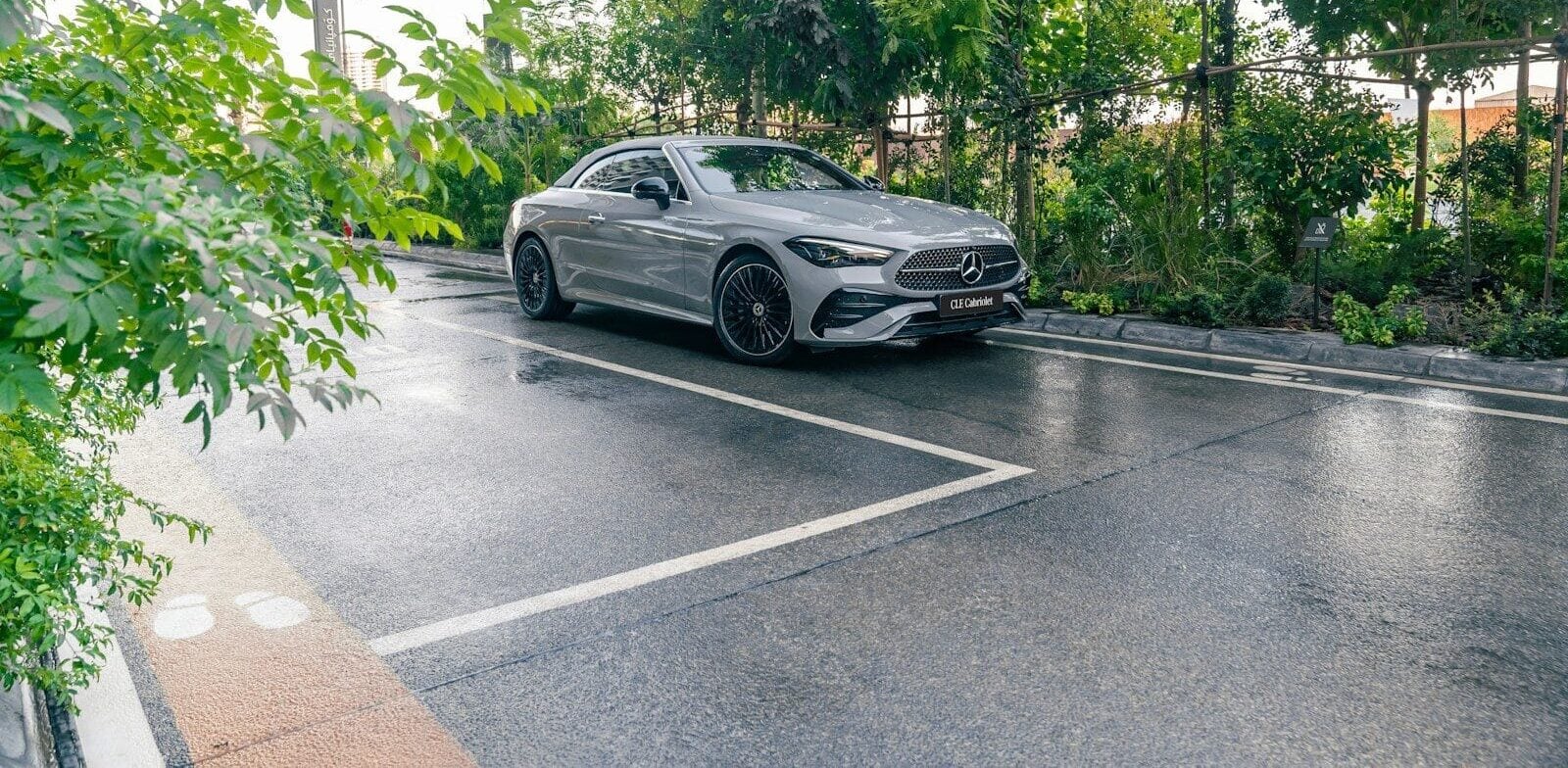 A silver car parked on a wet road