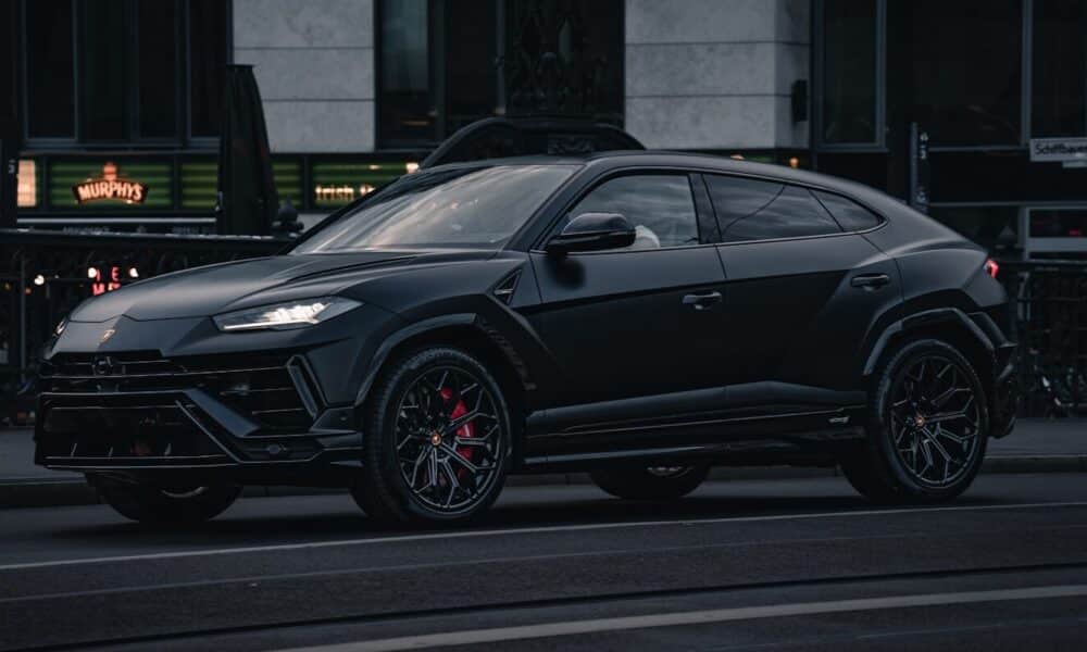 A black lamborghini urus suv parked on the street.