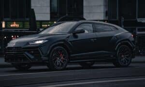 A black lamborghini urus suv parked on the street.