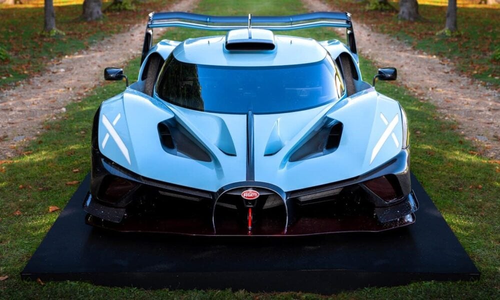 A sleek, white bugatti racecar on display.